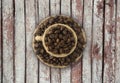 ÃÂ¡offee beans and a cup on a wooden background.